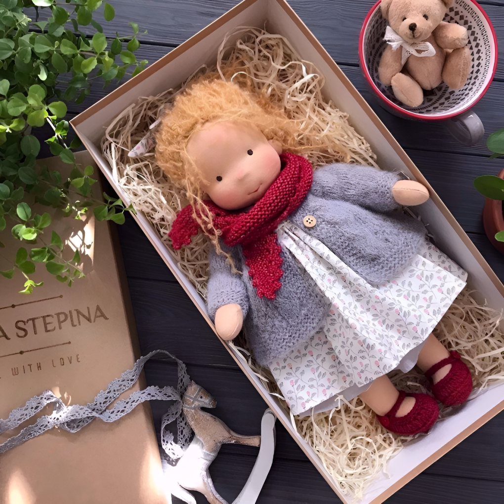 Soft Waldorf doll, made by hand from natural materials, ideal for young children.