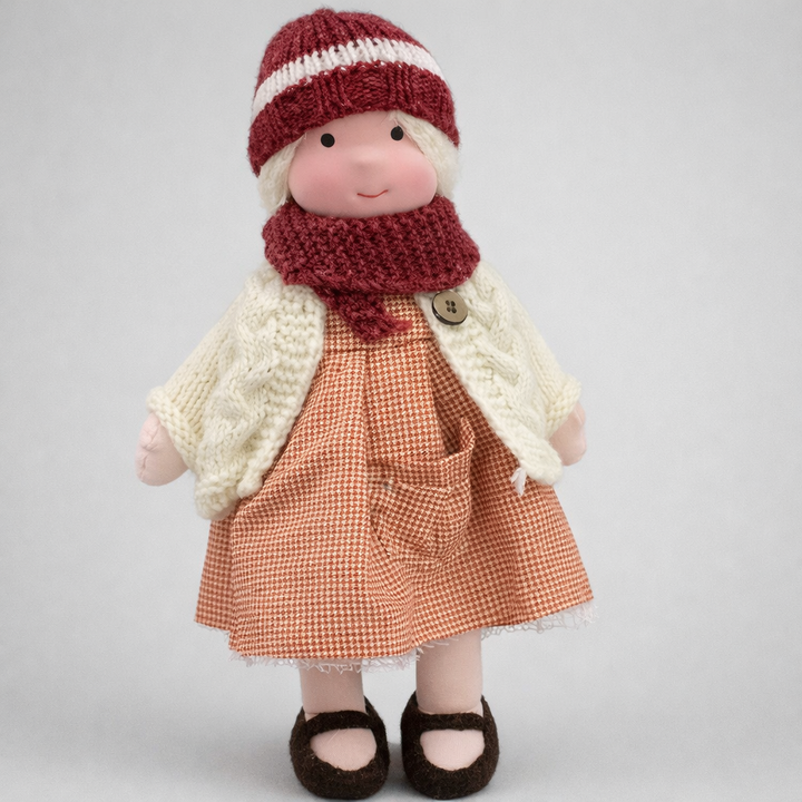 Girls' handmade Waldorf doll with a sweet expression, ideal for imaginative play.
