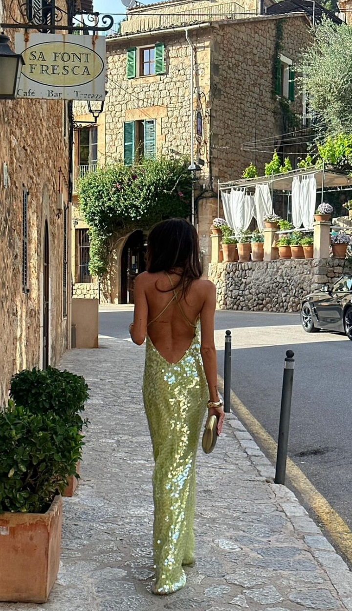 Fashionable women's green sequin party dress showcasing a sophisticated square collar and daring backless detail.