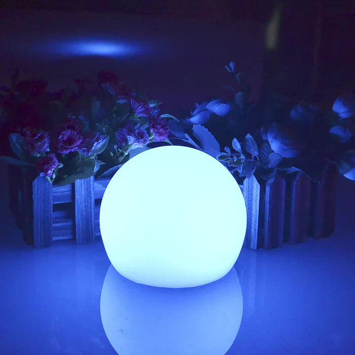 Enchanting GlowSphere spherical garden light, LED, color changing, creates vibrant outdoor ambiance.
