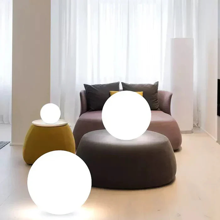 GlowSphere LED spherical outdoor light illuminating a garden at dusk, creating a magical ambiance.