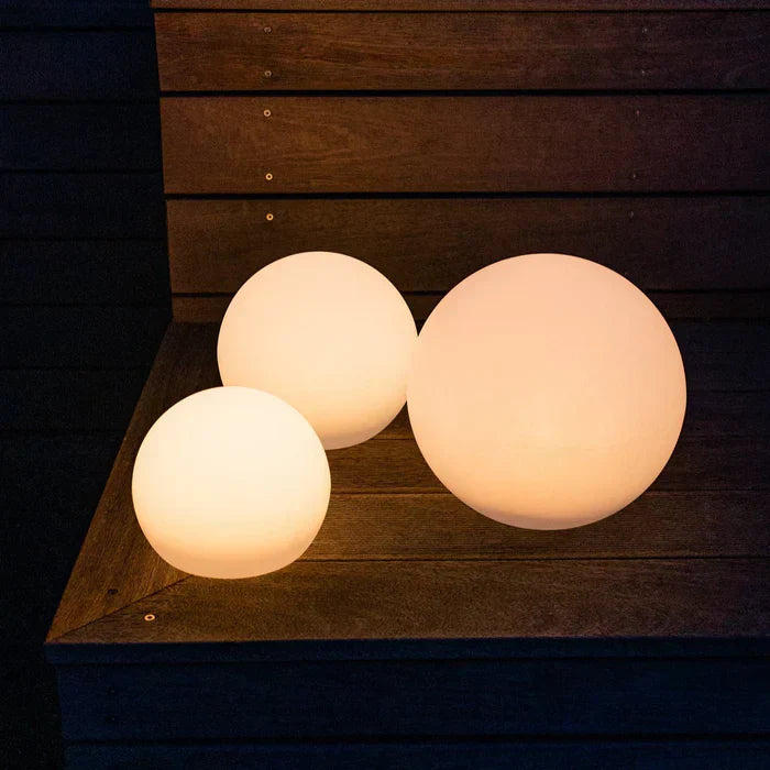 Rechargeable spherical outdoor light, GlowSphere LED, creates enchanting ambiance for gardens & parties.