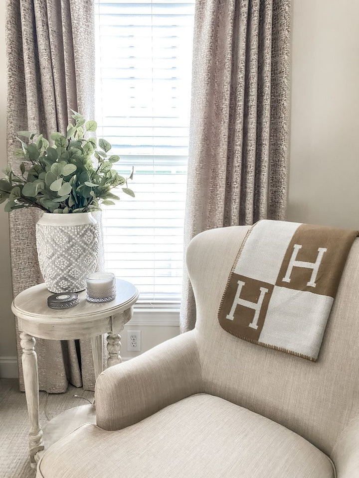 Elegant gold cashmere wool throw, enhances living room or bedroom decor with style.