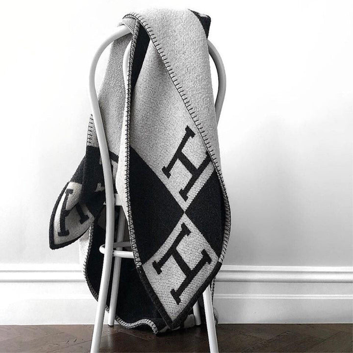 Cozy gold throw, blend of cashmere & wool, adds warmth and luxury to decor.