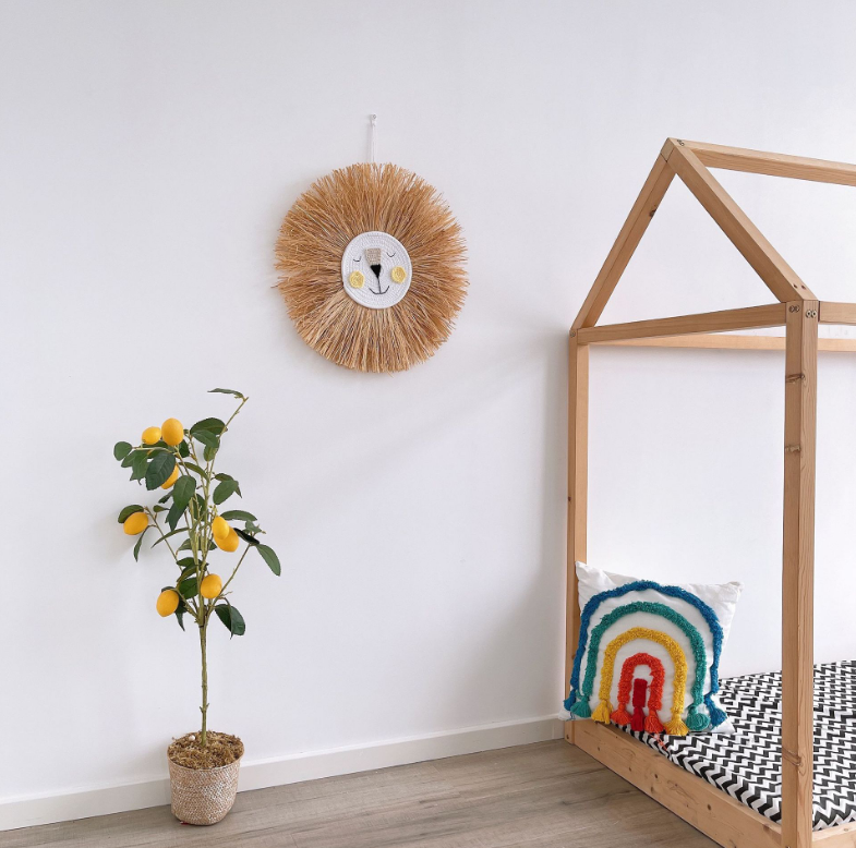 Whimsical rattan bear head wall decor. Eco-friendly animal wall art for a cozy children's nursery.