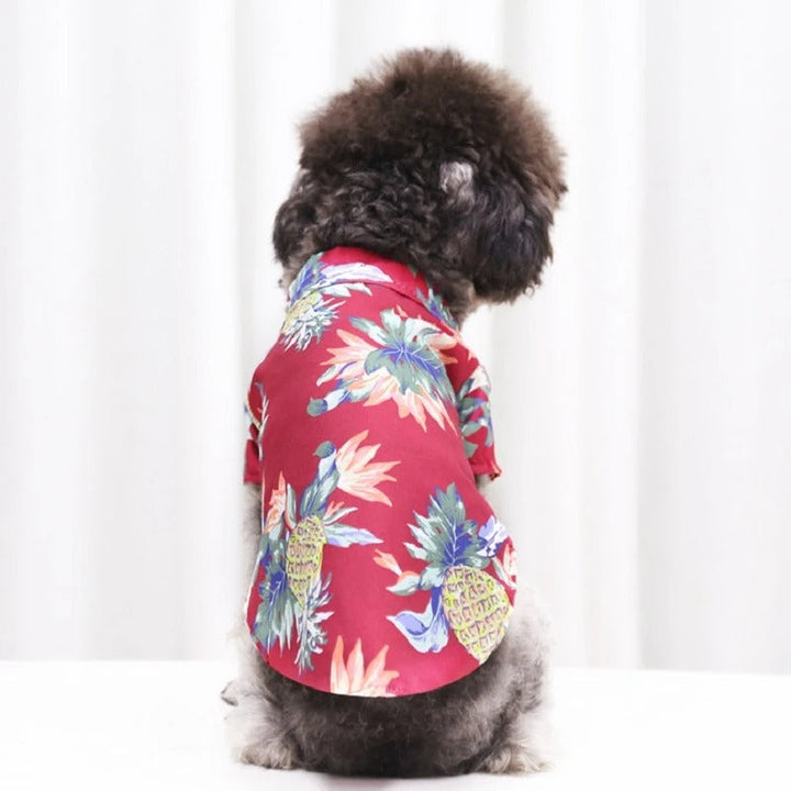 Hawaiian dog shirt with vibrant tropical patterns, featuring pineapples and foliage in bold colors for pet summer style.
