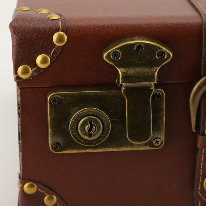 Vintage leather luggage, a heritage brown carry-on bag with an alloy lock, perfect for stylish unisex travel.