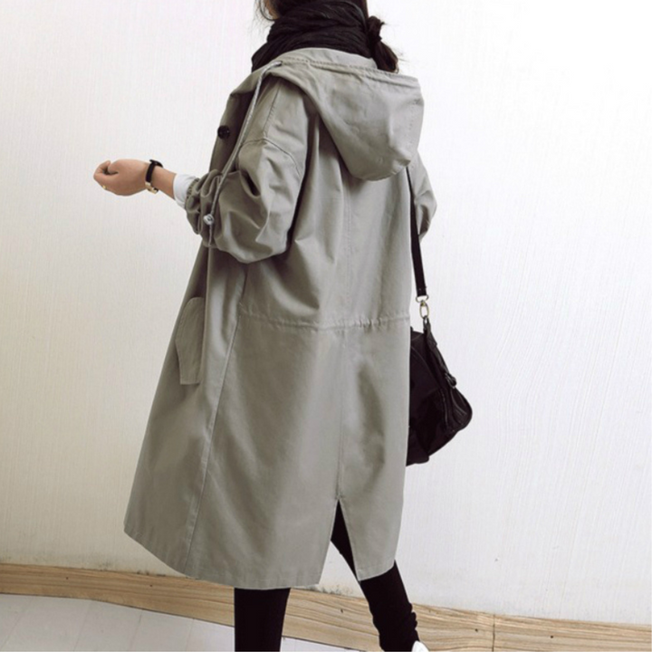 Women's elegant long rain trench coat, hooded and waterproof, a must-have for versatile autumn fashion.