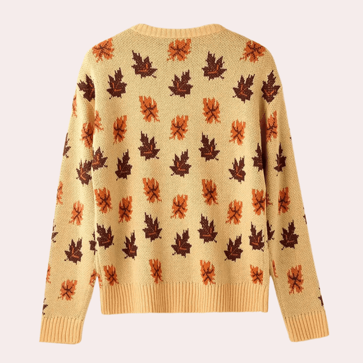 Close-up of the women's knitted leaf pattern on a cozy long sleeve khaki jumper. Ideal for winter casual wear.