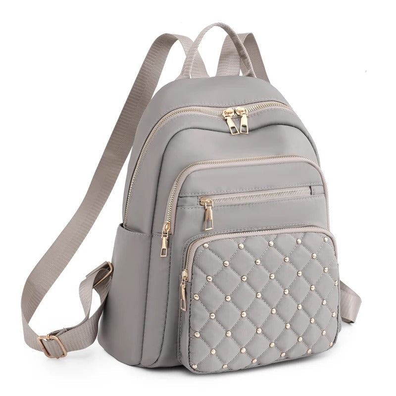 Black women's lightweight water-resistant nylon backpack, ideal for travel, school, or daily commute.
