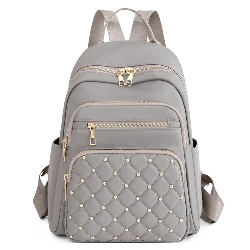 Open women's lightweight nylon backpack, showcasing spacious interior for books, laptop, and travel essentials.