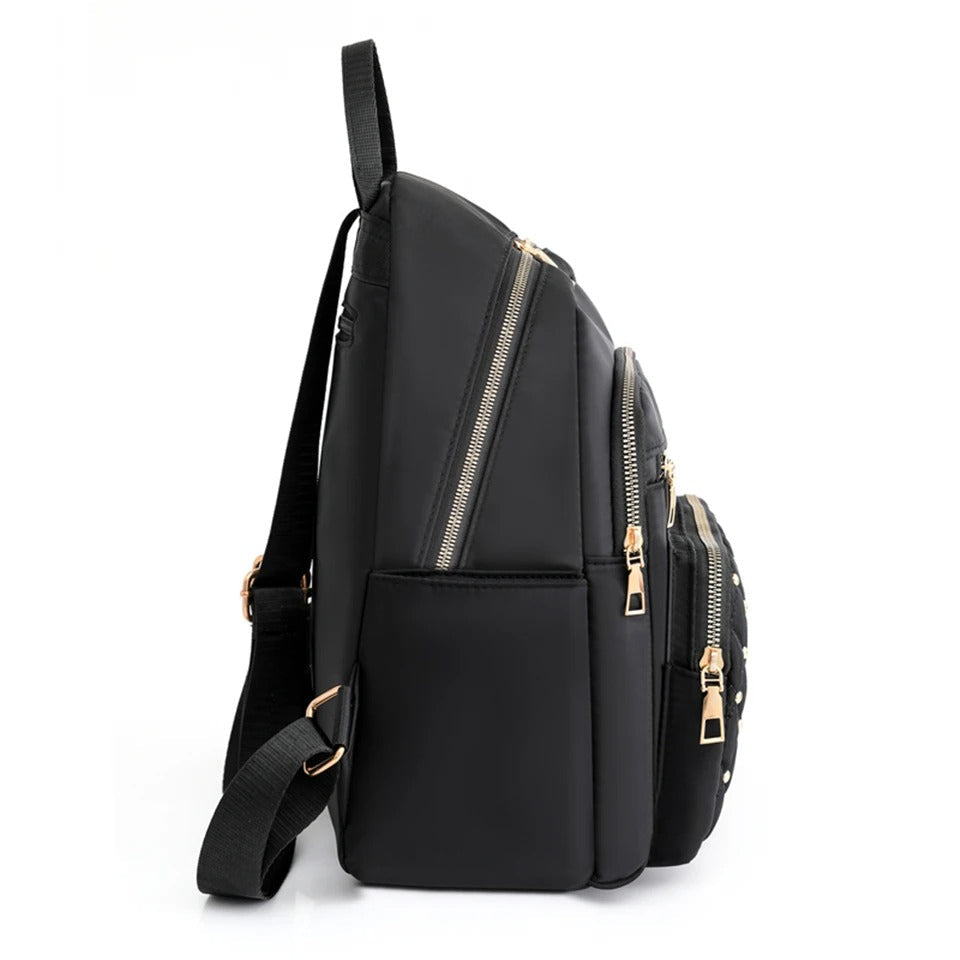 Back view of a women's lightweight nylon backpack featuring ergonomic design & comfortable padded straps.