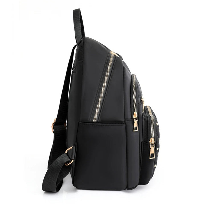 Back view of a women's lightweight nylon backpack featuring ergonomic design & comfortable padded straps.