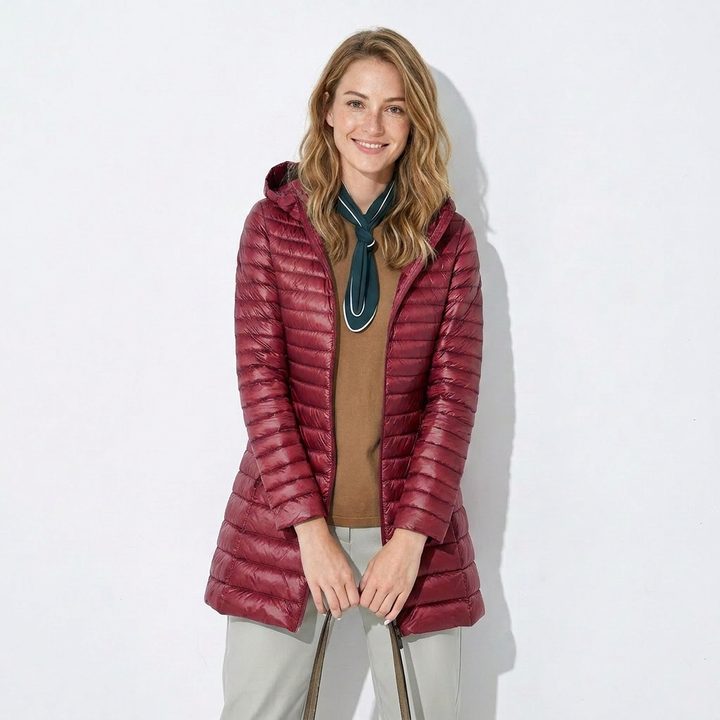 Women's long puffer coat, a warm burgundy hooded jacket for winter, featuring full zip-up closure.