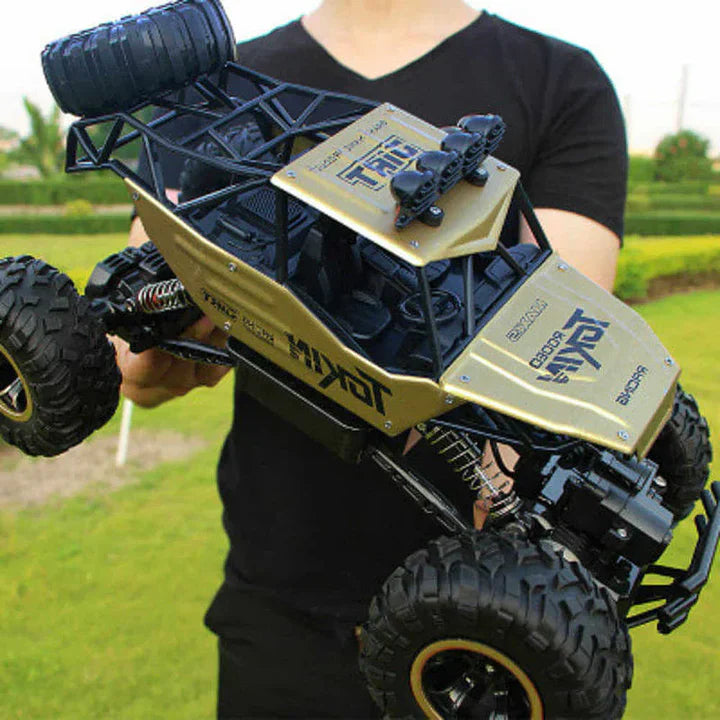 Action shot of a red 4WD RC monster truck speeding through dirt, ideal for kids' all-terrain adventures.