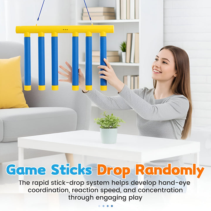 Children playing a falling stick reaction game, enhancing motor skills and concentration.