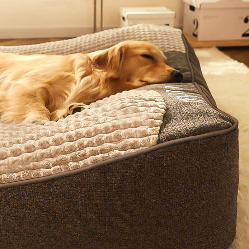 Durable large dog bed, orthopedic design with neck support & washable cover for pet comfort.