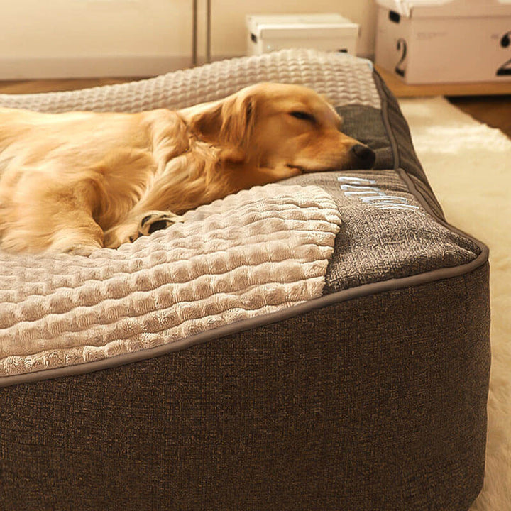 Durable large dog bed, orthopedic design with neck support & washable cover for pet comfort.