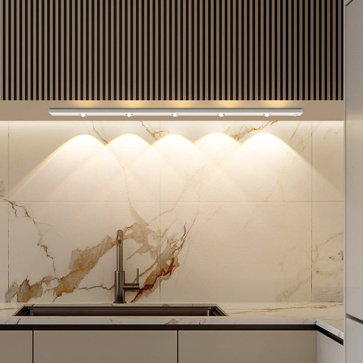 "LED motion sensor under cabinet light with cat-eye bulb, adjustable luminance, and magnetic installation in kitchen setting.