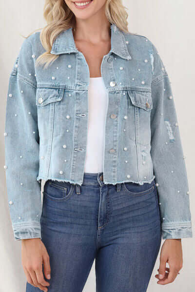 Light blue denim jacket with elegant pearl trim for women.