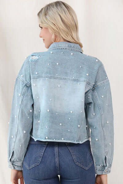 Stylish light blue denim jacket with pearl trim, perfect for spring fashion.