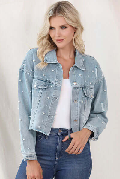 Unique women's light blue denim jacket, embellished with sophisticated pearl trim.