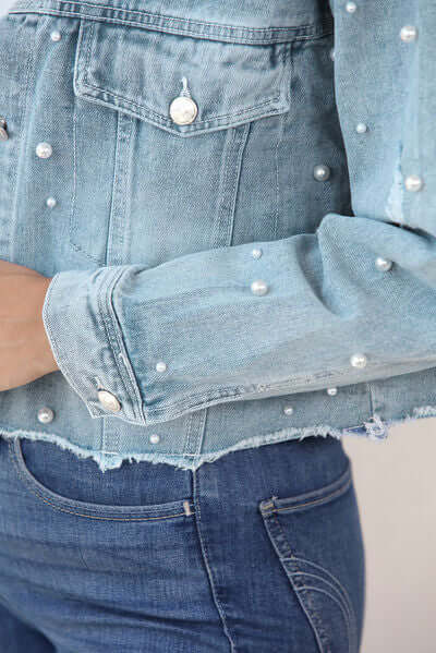 Fashion-forward women's pearl trim denim jacket in a light blue shade.
