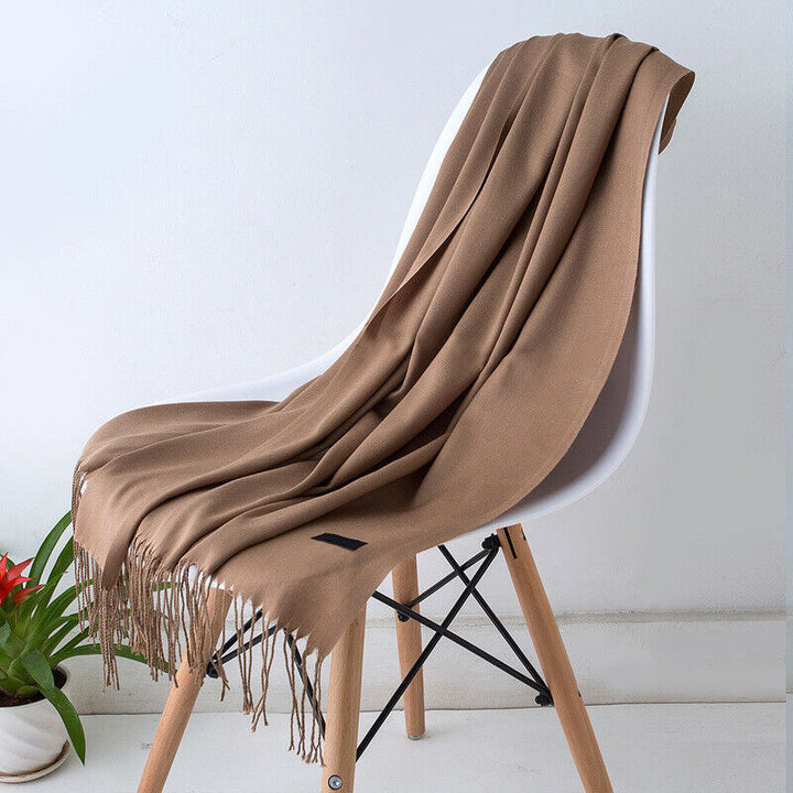 Women's long, soft cashmere scarf, a luxurious solid color winter accessory providing warmth.