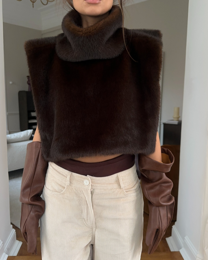 Cozy women's dark brown faux fur turtleneck vest, ideal for stylish winter layering fashion.