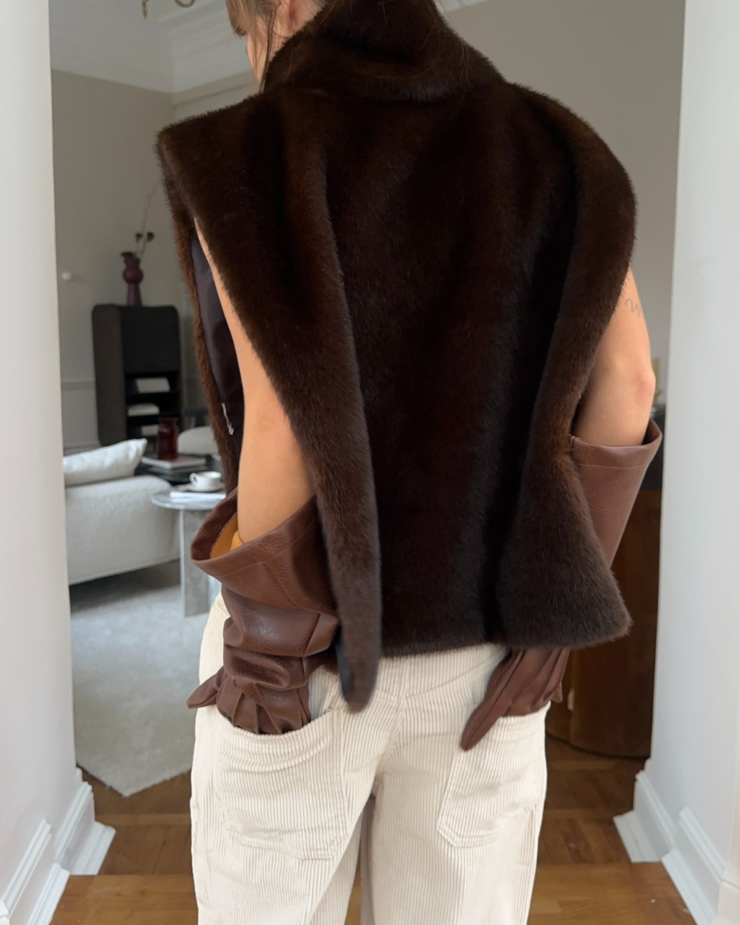 Stylish dark brown faux fur sleeveless vest for women, a cozy and fashionable winter piece.
