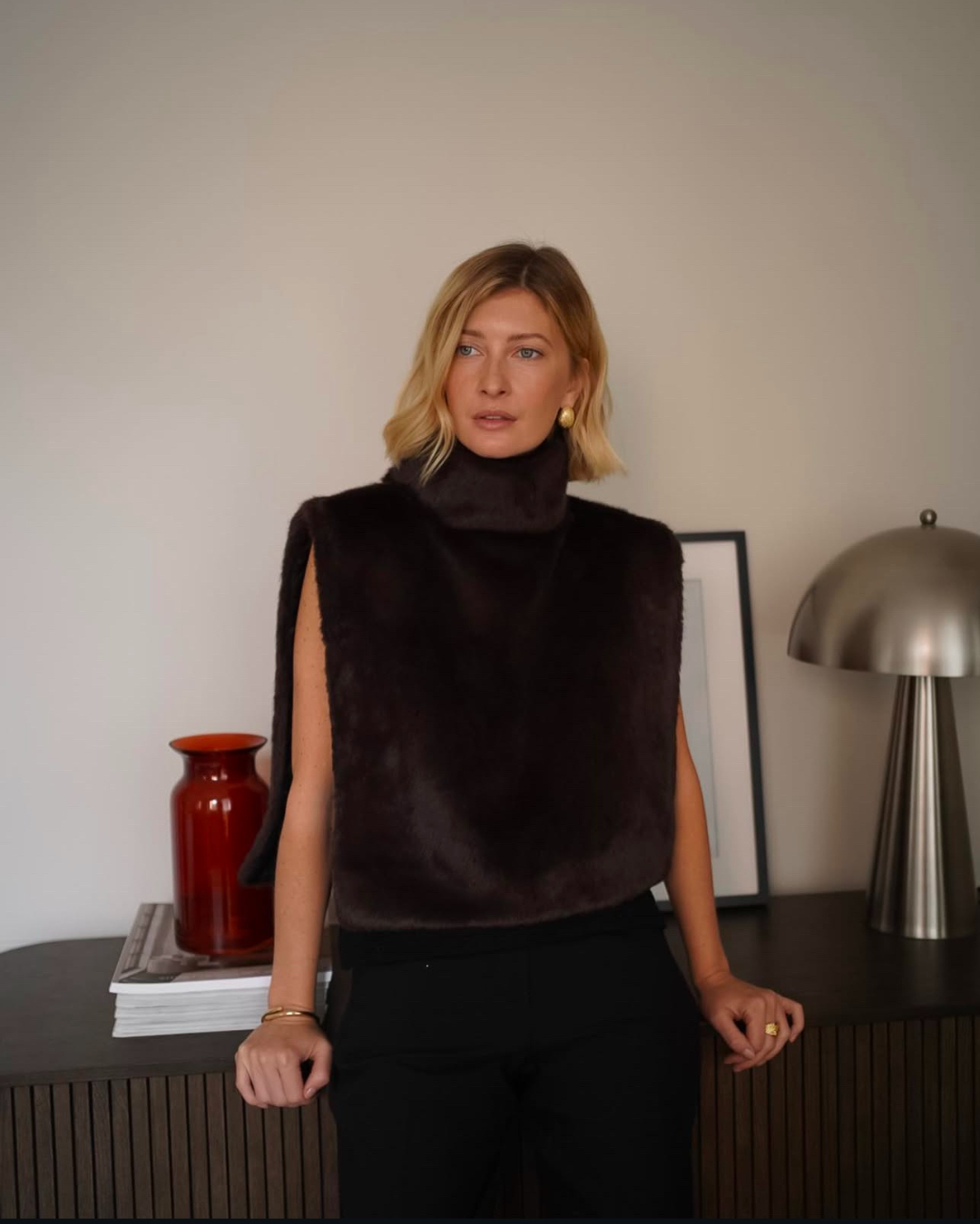 Plush dark brown faux fur turtleneck vest for women, offering warmth and a luxurious, cozy look.