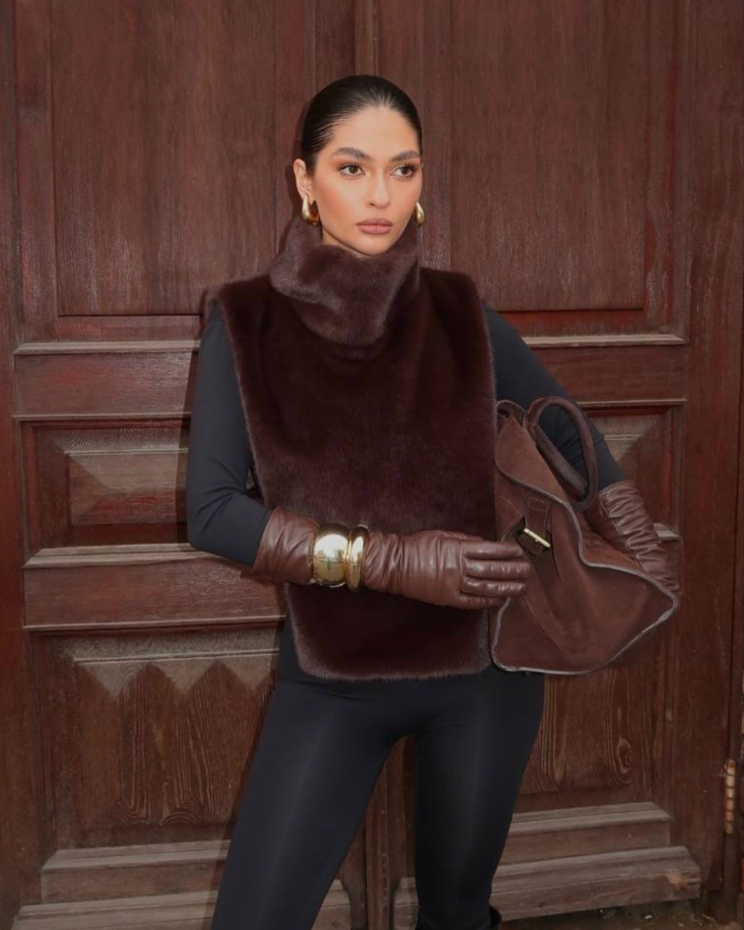Women's sleeveless dark brown faux fur vest, featuring a warm, stylish turtleneck for winter.