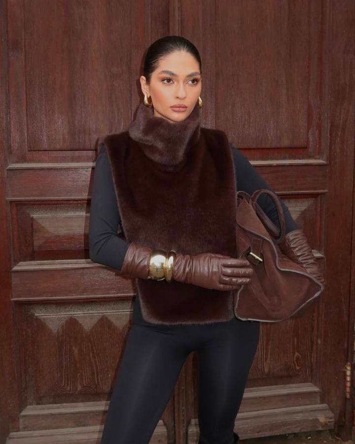 Women's sleeveless dark brown faux fur vest, featuring a warm, stylish turtleneck for winter.