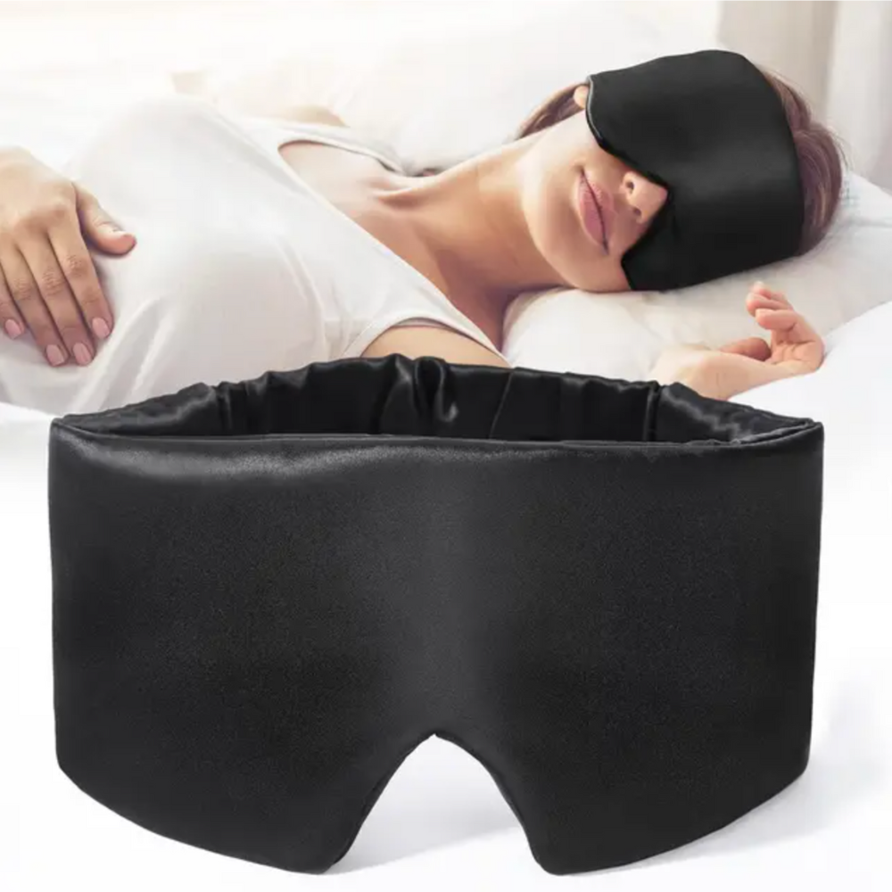 Luxurious unisex silk sleep mask, blocks 100% light; shown in elegant black with adjustable strap for comfortable wear.