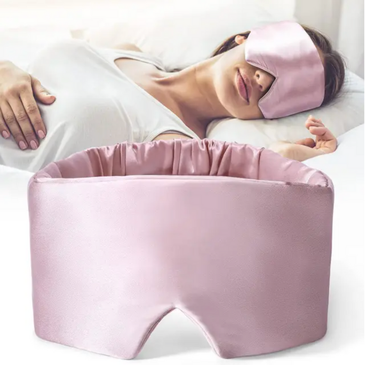 Luxurious unisex silk sleep mask, blocks 100% light; shown in elegant black with adjustable strap for comfortable wear.