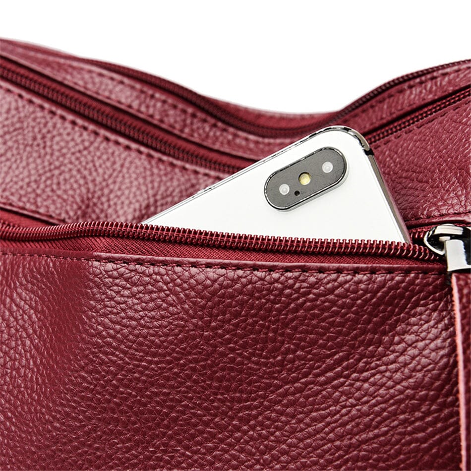 Detailed view of a women's luxury multi-color leather handbag, showcasing exquisite craftsmanship.
