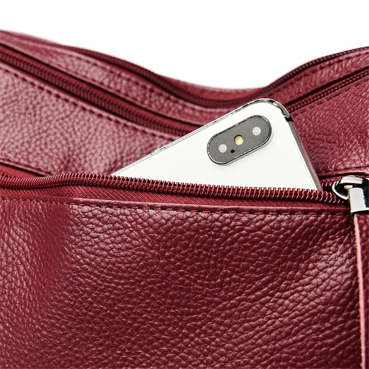 Detailed view of a women's luxury multi-color leather handbag, showcasing exquisite craftsmanship.