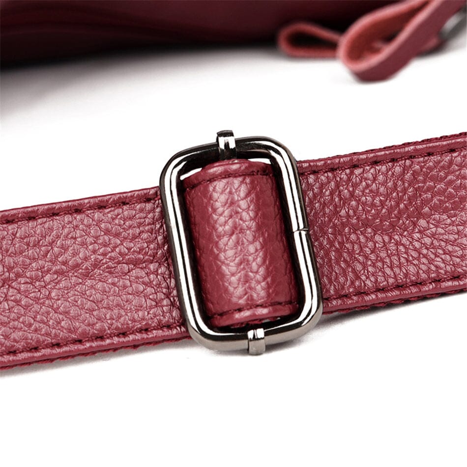 Sleek women's luxury leather handbag with unique texture and secure zip closure.