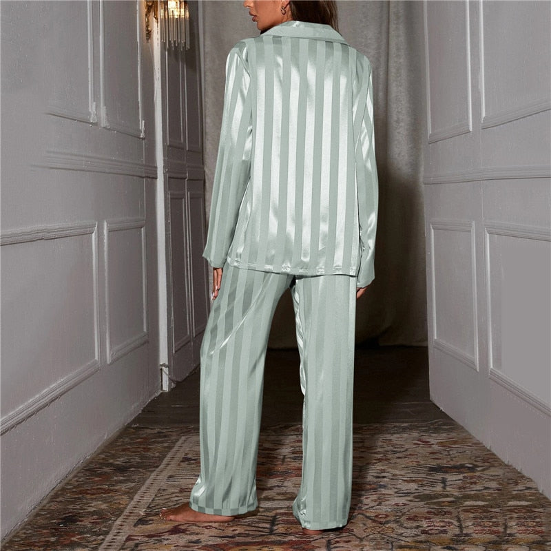 Woman enjoying a morning coffee in a luxurious silk-feel pyjama set. Comfortable relaxation wear.