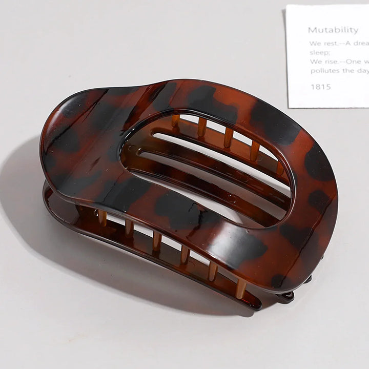 Elegant matte duckbill hair clip, oval design for a sophisticated women's look.