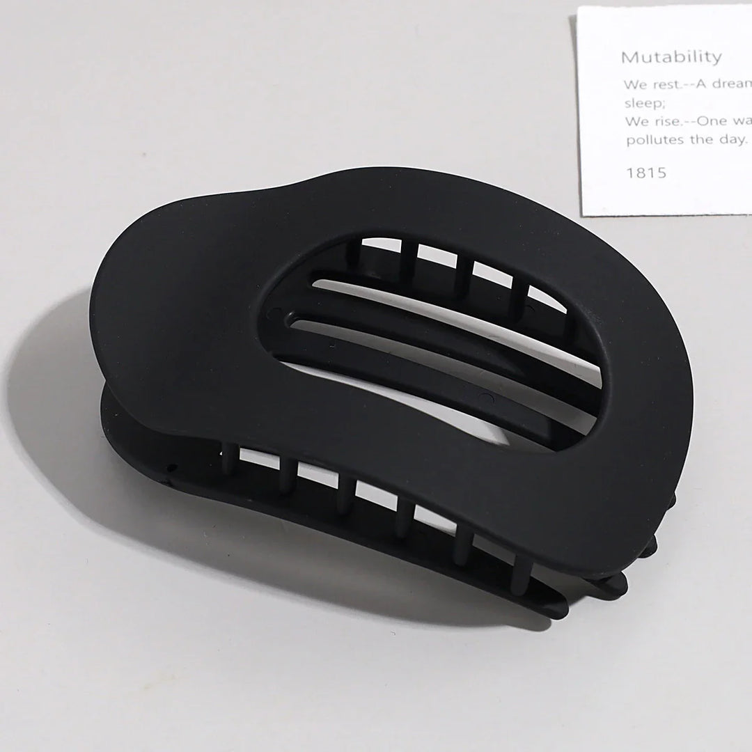 Flat oval matte claw clip, durable hair accessory for secure hold on thick hair.