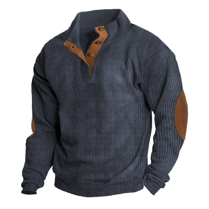 Man by campfire wearing Asher men's sweater. Comfortable, warm outdoor pullover, ideal for camping & chilly evenings.