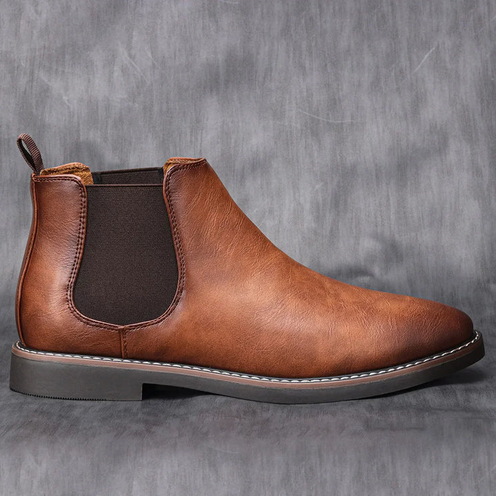 Front view of classic men's Chelsea boots. Black leather slip-on style, ready for versatile casual or formal wear.