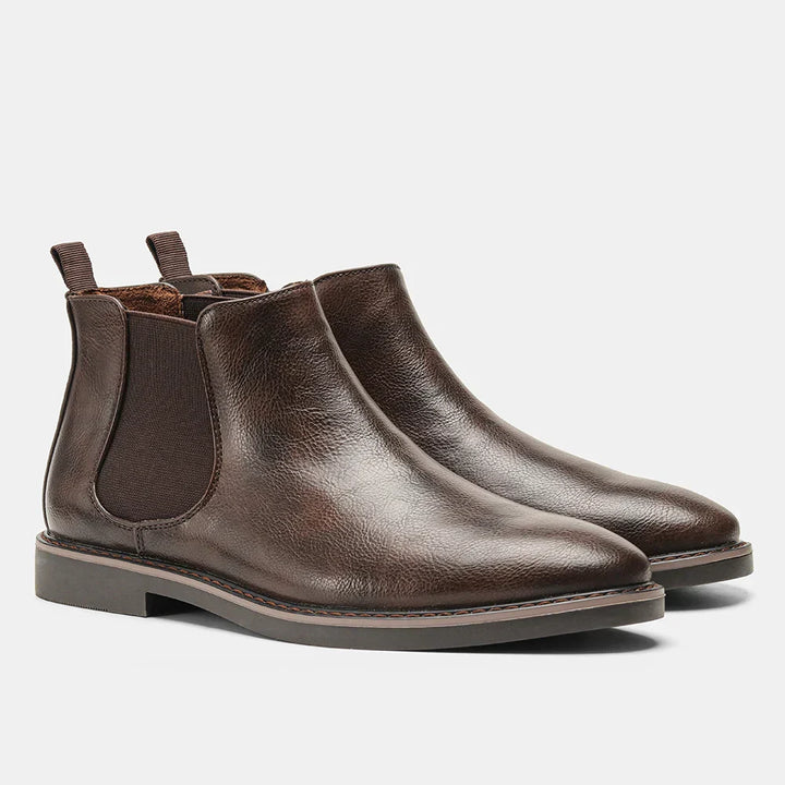 Detail of elastic side panel and pull tab on men's slip-on Chelsea boots for easy wear. Comfortable ankle footwear.
