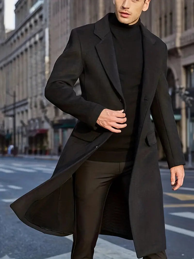 Long black slim fit men's trench coat. Essential winter outerwear with a sophisticated notched lapel for elegant style.