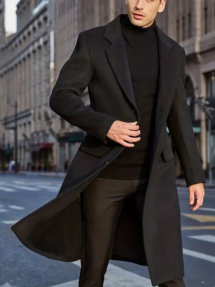 Long black slim fit men's trench coat. Essential winter outerwear with a sophisticated notched lapel for elegant style.