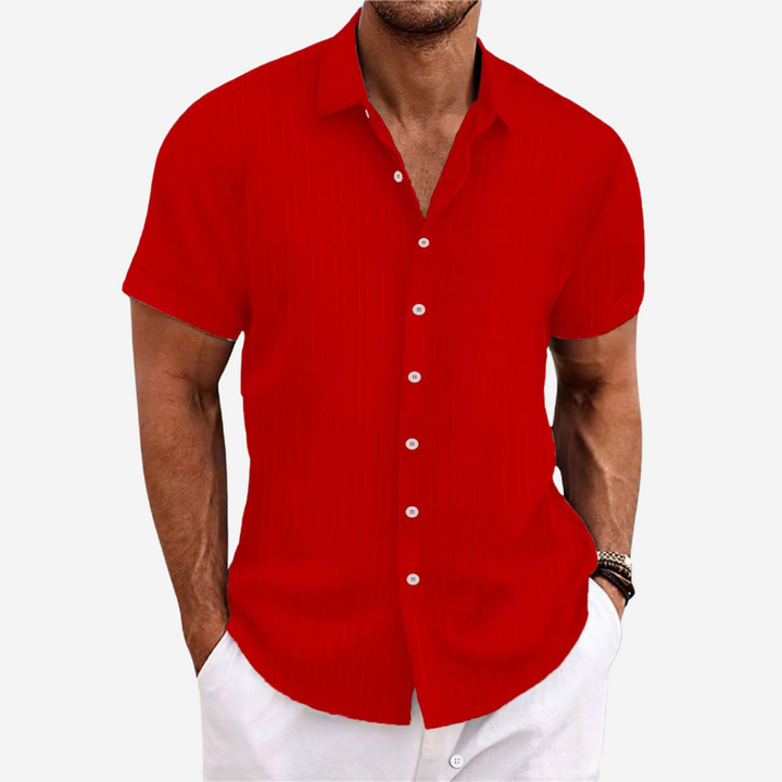 Detail of the breathable fabric on a men's casual short-sleeve button-up shirt, ideal for warm weather.