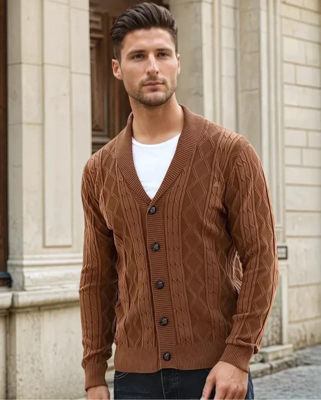 Close-up of a men's cable knit V-neck cardigan, showcasing rich texture and stylish shawl collar detailing.