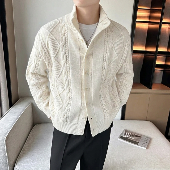 Close-up of a men's button-up cable knit cardigan, highlighting the stand collar and intricate texture.