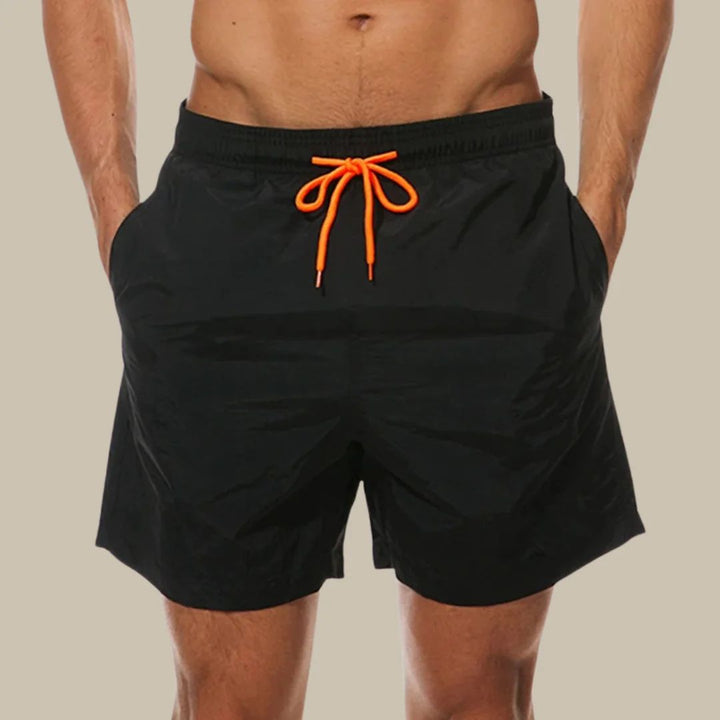 Men's casual swim shorts with drawstring waist & side pockets, ideal for beach & summer wear.